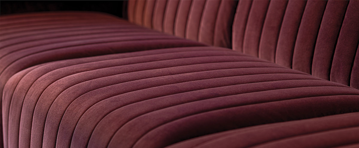 Burgundy velvet quilted sofa